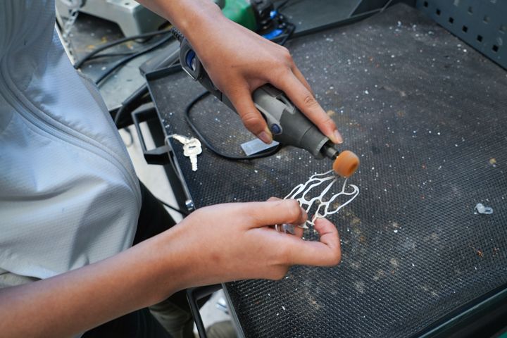 waterjet cut aluminum jewelry being finished